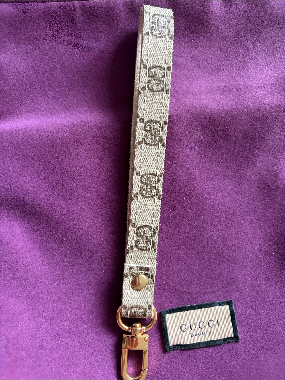 Gucci Beige Monogram Wristlet Key Holder with Black Tassel and Gold Hardware